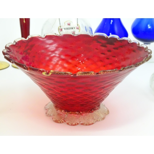 301 - A quantity of assorted glassware to include pedestal blue glass vases, candlesticks, decanters, pede... 