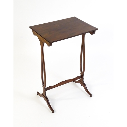 305 - A late 19thC mahogany lamp table with a figured rectangular top above pierced sides, a shaped stretc... 