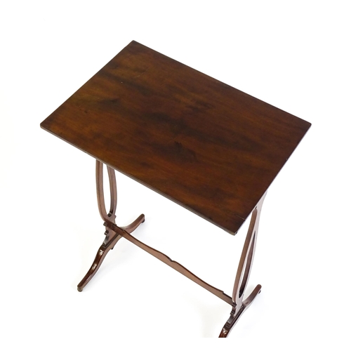 305 - A late 19thC mahogany lamp table with a figured rectangular top above pierced sides, a shaped stretc... 