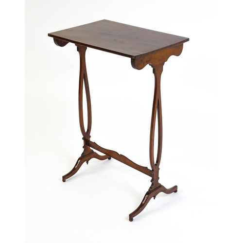 305 - A late 19thC mahogany lamp table with a figured rectangular top above pierced sides, a shaped stretc... 