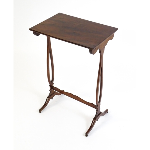 305 - A late 19thC mahogany lamp table with a figured rectangular top above pierced sides, a shaped stretc... 