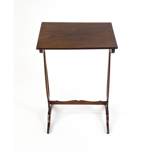 305 - A late 19thC mahogany lamp table with a figured rectangular top above pierced sides, a shaped stretc... 