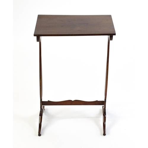 305 - A late 19thC mahogany lamp table with a figured rectangular top above pierced sides, a shaped stretc... 