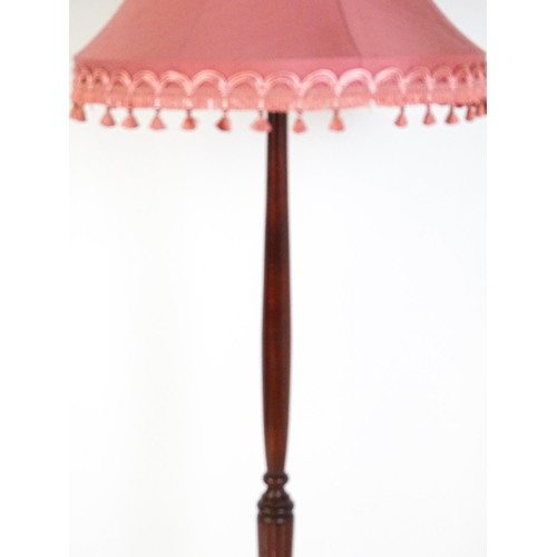 322 - A mahogany standard lamp with a turned tapering stem and circular base. 70