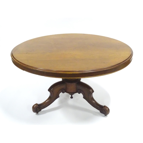 332 - A Victorian mahogany tilt-top breakfast table, the circular top supported by a turned baluster above... 