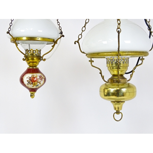 349 - Two pendant oil lamps one with ceramic reservoir with floral detail. Largest approx. 11