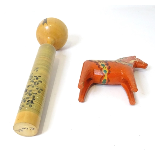 369 - A Japanese turned wooden Kokeshi style doll with painted detail. Together with a wooden model of a h... 