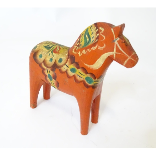 369 - A Japanese turned wooden Kokeshi style doll with painted detail. Together with a wooden model of a h... 