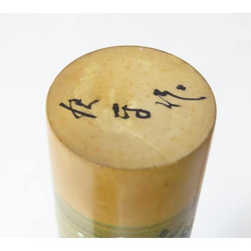 369 - A Japanese turned wooden Kokeshi style doll with painted detail. Together with a wooden model of a h... 