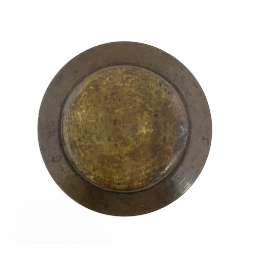 370 - A Middle Eastern brass dish with script and banded detail. Approx. 9 1/2