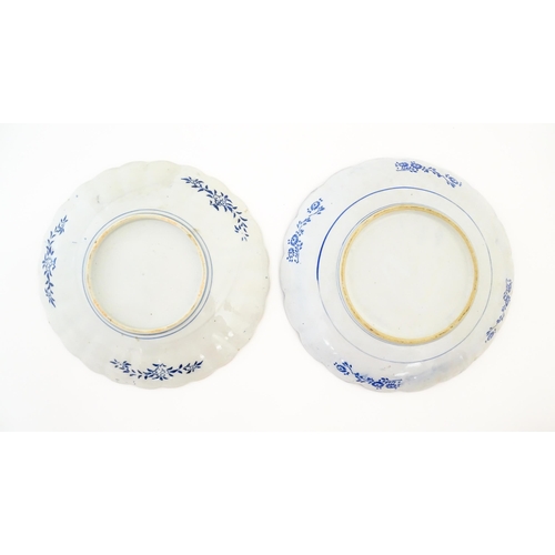 379 - Two Japanese chargers with scalloped edges decorated in the Imari palette depicting flowers and foli... 
