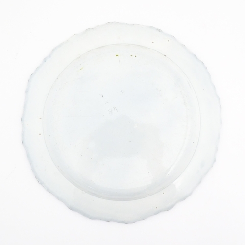 392 - A Liverpool blue and white pearlware plate with feathered edge decorated with chinoiserie detail dep... 
