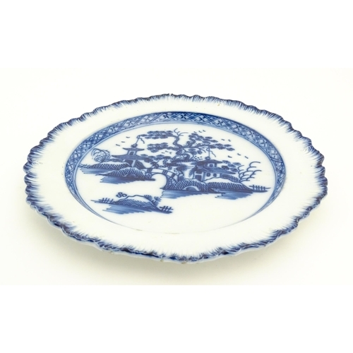 392 - A Liverpool blue and white pearlware plate with feathered edge decorated with chinoiserie detail dep... 