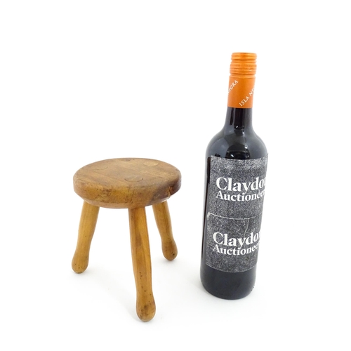 407 - A 20thC fruitwood model of a milking stool. Approx. 6 1/4