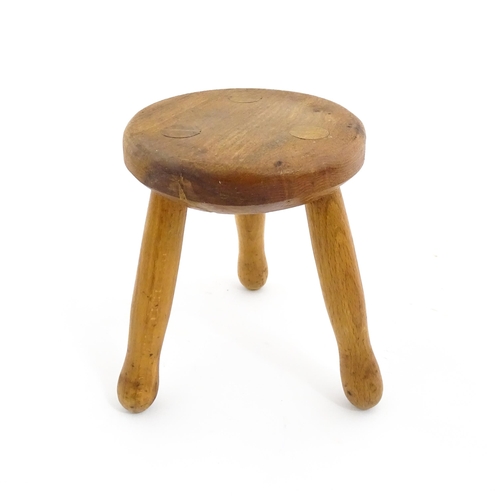 407 - A 20thC fruitwood model of a milking stool. Approx. 6 1/4