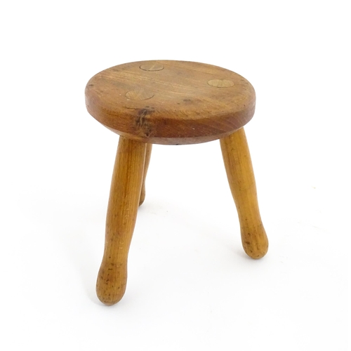 407 - A 20thC fruitwood model of a milking stool. Approx. 6 1/4