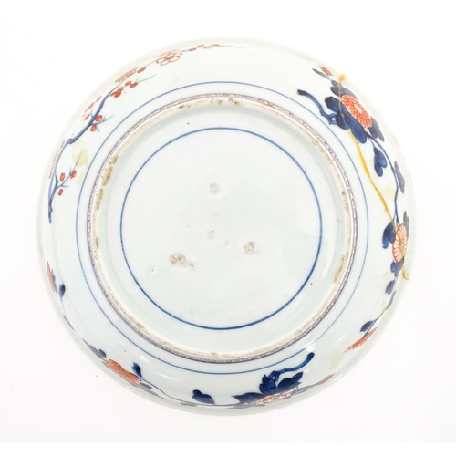 411 - A Japanese plate decorated in the Imari palette decorated with flowers and foliage, with further flo... 