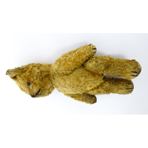 412 - Toy: An early 20thC teddy bear with stitched nose and mouth and articulated limbs. Approx. 9 1/4