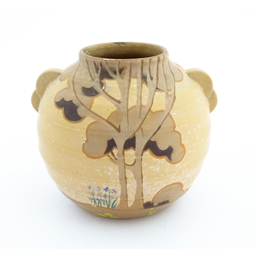 413 - An Art Deco vase of globular form with twin handles decorated with trees in a landscape. Marked Engl... 