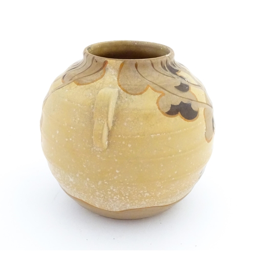 413 - An Art Deco vase of globular form with twin handles decorated with trees in a landscape. Marked Engl... 