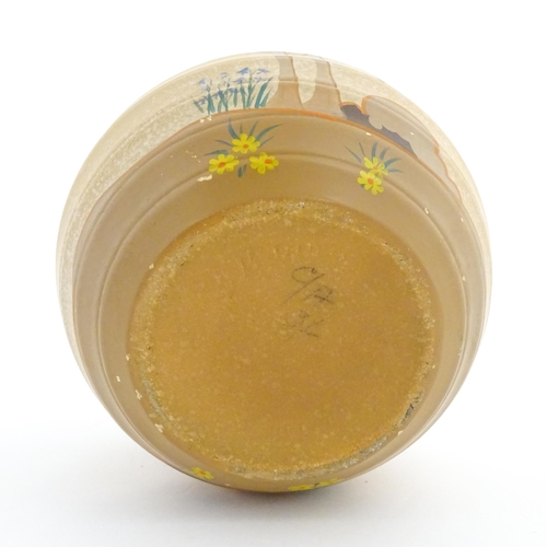 413 - An Art Deco vase of globular form with twin handles decorated with trees in a landscape. Marked Engl... 