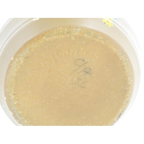 413 - An Art Deco vase of globular form with twin handles decorated with trees in a landscape. Marked Engl... 