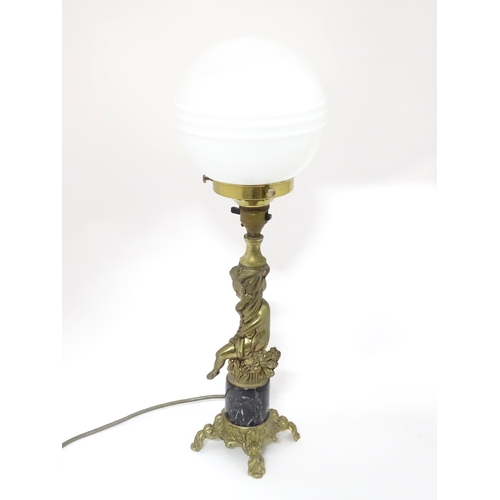 416 - A 20thC cast table lamp with cherub detail to column. Approx. 18 1/2