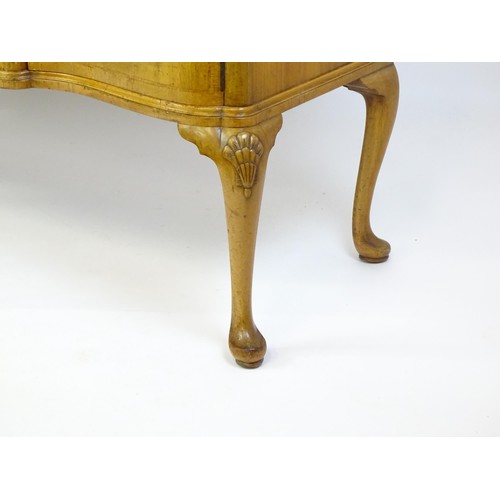 617 - An early / mid 20thC Waring & Gillows walnut sideboard with a serpentine shaped front and a crossban... 