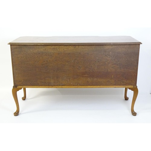 617 - An early / mid 20thC Waring & Gillows walnut sideboard with a serpentine shaped front and a crossban... 