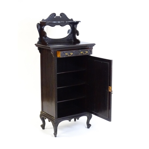 627 - A late Victorian ebonised side cabinet with a mirrored upstand, a moulded top and a single frieze dr... 