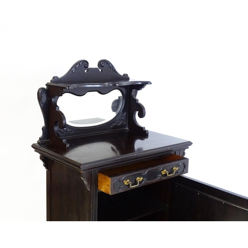 627 - A late Victorian ebonised side cabinet with a mirrored upstand, a moulded top and a single frieze dr... 