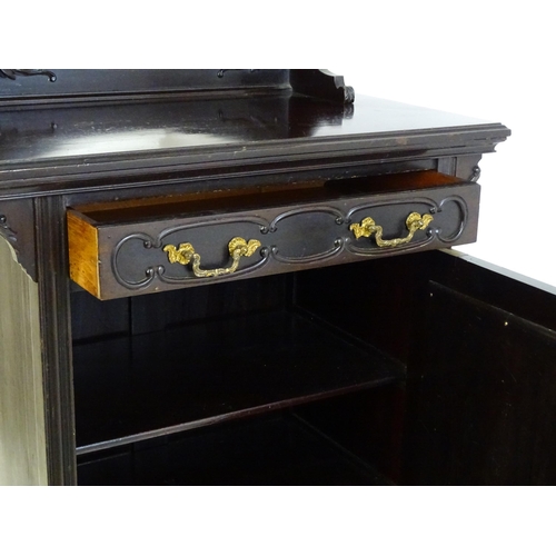 627 - A late Victorian ebonised side cabinet with a mirrored upstand, a moulded top and a single frieze dr... 