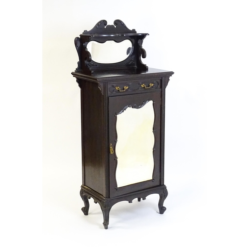 627 - A late Victorian ebonised side cabinet with a mirrored upstand, a moulded top and a single frieze dr... 