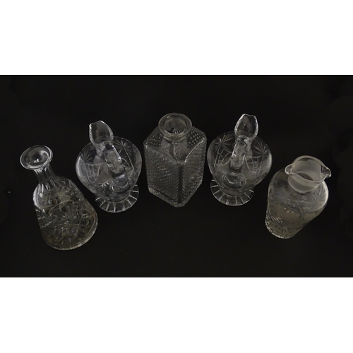 628 - A quantity of assorted cut glass decanters, claret jugs, etc. Largest approx. 11 1/4