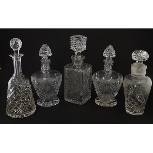 628 - A quantity of assorted cut glass decanters, claret jugs, etc. Largest approx. 11 1/4