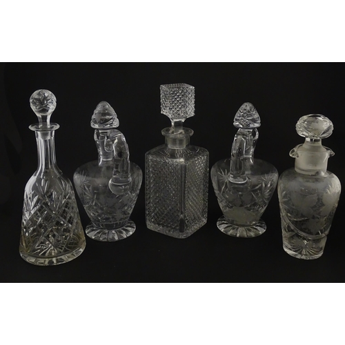 628 - A quantity of assorted cut glass decanters, claret jugs, etc. Largest approx. 11 1/4