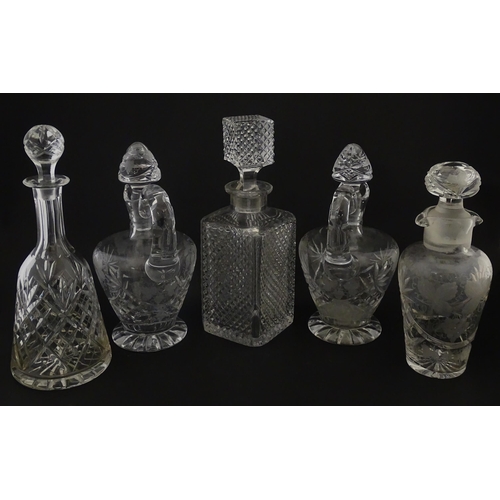 628 - A quantity of assorted cut glass decanters, claret jugs, etc. Largest approx. 11 1/4