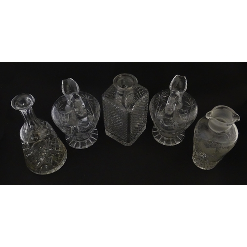 628 - A quantity of assorted cut glass decanters, claret jugs, etc. Largest approx. 11 1/4