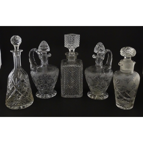 628 - A quantity of assorted cut glass decanters, claret jugs, etc. Largest approx. 11 1/4