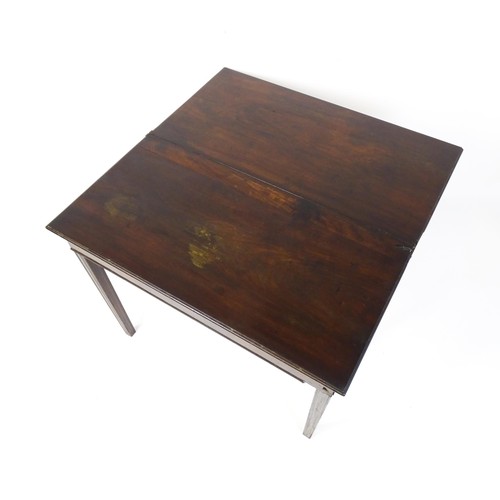 630 - An 18thC mahogany tea table raised on five chamfered tapered legs. 36