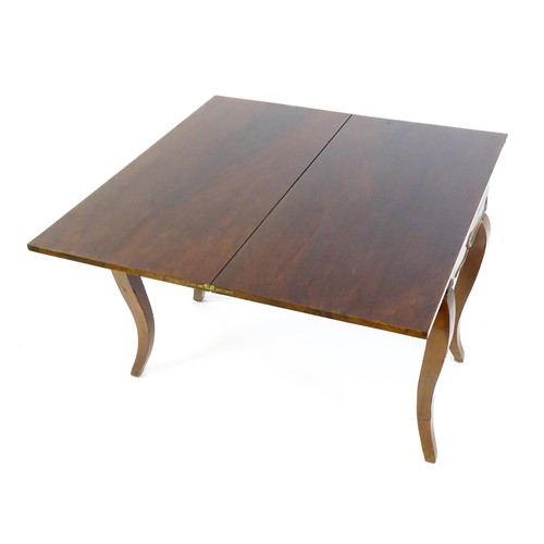 639 - An early 20thC mahogany tea table of large proportions, the hinged rectangular top above a shell car... 