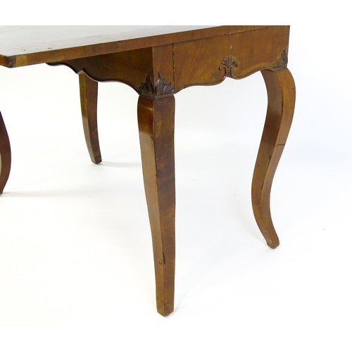 639 - An early 20thC mahogany tea table of large proportions, the hinged rectangular top above a shell car... 