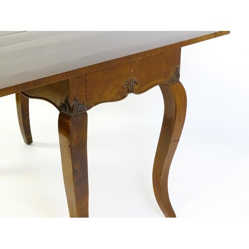 639 - An early 20thC mahogany tea table of large proportions, the hinged rectangular top above a shell car... 