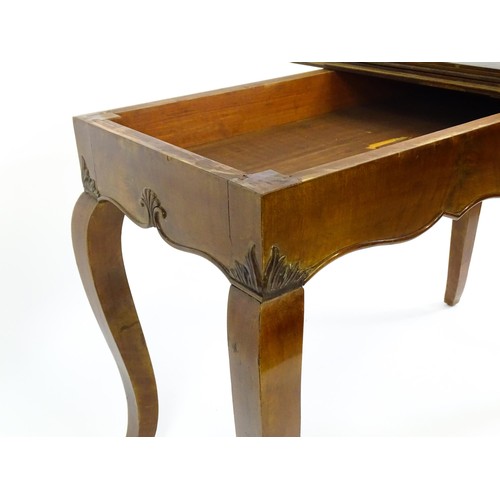 639 - An early 20thC mahogany tea table of large proportions, the hinged rectangular top above a shell car... 