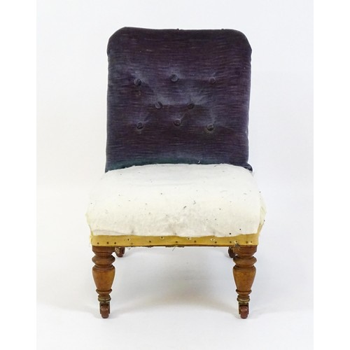 641 - An early 20thC nursing chair with a deep buttoned backrest and sprung seat raised on turned tapering... 