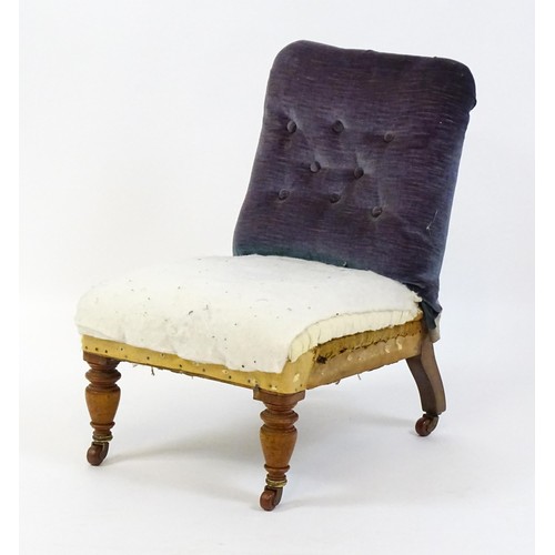 641 - An early 20thC nursing chair with a deep buttoned backrest and sprung seat raised on turned tapering... 
