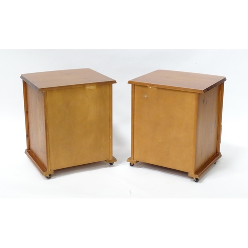 647 - A pair of pine bedside cabinets, each with three drawers with turned wooden handles. 18