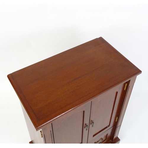 660 - A mahogany veneered television cabinet  27