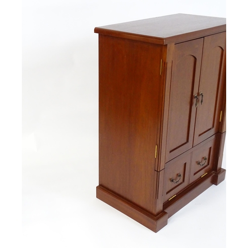 660 - A mahogany veneered television cabinet  27