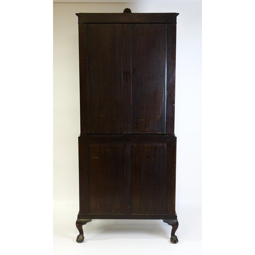 664 - An early 20thC mahogany bureau bookcase with a carved cornice above two astragal glazed doors and a ... 